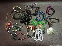 Group view of all necklaces and bracelets spread on surface
