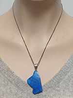 Necklace on display bust showing full view of pendant and chain