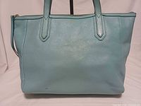 Front view of sky blue Fossil leather tote showing overall look and Fossil logo
