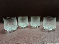 Front view of four textured Iittala Ultima Thule glasses