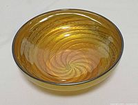 Oblique view showing overall bowl shape and iridescent spiral pattern