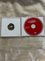 Open jewel case showing disc and back of booklet