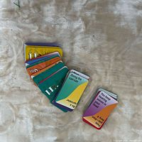 Stack of multicolored Hilarium cards fanned out