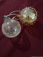 Both ornaments side by side showing overall design, cords, colour, relative size