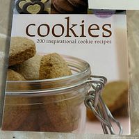 Front cover of cookbook showing title and jar of cookies