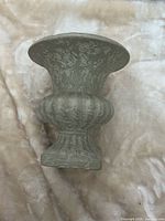 Full view of vase showing pedestal base and fluted body