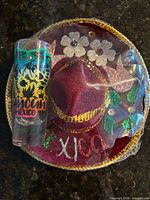 Shot glass beside decorative sombrero in packaging