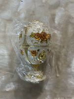 Full view of ornament wrapped in plastic