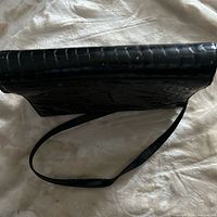 Side profile showing patent leather texture and strap