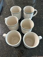 six stoneware mugs top view