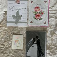 Front view of four wedding greeting cards displayed