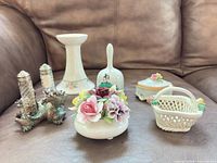 Group shot of all porcelain and metal items on leather couch