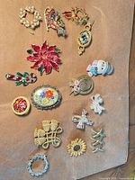All sixteen brooches displayed front side