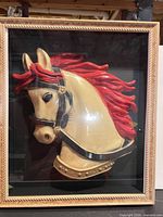 Front view of framed resin carousel horse head shadowbox showing relief, glass, and frame detail