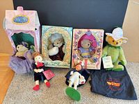 Front view of all six items: three boxed Muffy bears, Steiff Sprout bear with bag, two cloth dolls