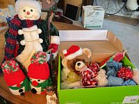 overview of lot showing plush snowman figure, knit snowmen, angel figurine, open box with plush bear and glass ornaments