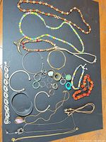 Overview of entire lot showing necklaces, bracelets, bangles, rings