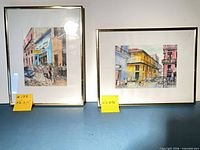 Both framed watercolors side by side with size tags