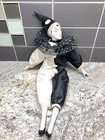 Full view of porcelain Pierrot doll showing costume and size