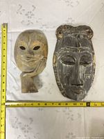 Front view of both masks with tape measure showing sizes