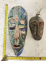 Both masks with tape measure for scale