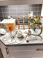 Full lot showing Moulinex attachment pieces, original box, wooden wine rack and display wine bottles