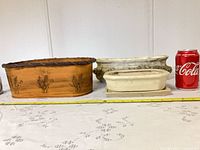 Front view of all three planters with soda can and measuring tape for scale