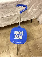 Top view of stool showing blue seat and handle