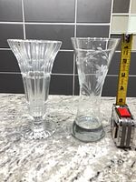 Both small glass vases beside tape for height reference