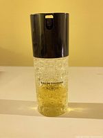 Front view of Worth Je Reviens Eau de Cologne bottle showing label and remaining liquid