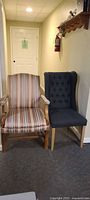 Two chairs side by side: grey button-back chair and striped fruitwood armchair