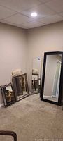 Four mirrors grouped: black frame, frameless, two silver/bronze framed
