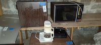 Kenmore microwave, mini fridge, Krups coffee maker, Salton grill grouped on tables