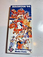 Front cover showing Broncos '94 media guide with player collage and 35th Anniversary title