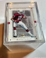 Stack of cards in clear acrylic case, top card visible