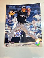 Full view of signed 8x10 photo showing autograph and hologram