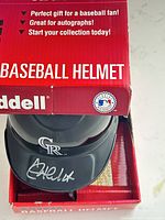 Helmet in original box showing Rockies logo and autograph