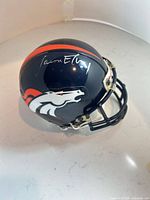 Left front view of signed Broncos mini helmet