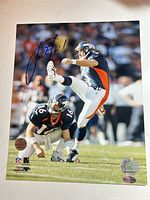 Full view of signed Jason Elam 8x10 photo showing autograph and action image
