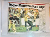 Front of lithograph showing action photo, headline and autograph