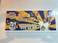 Front of the first day cover showing graphics, MVP text and images of Kurt Warner
