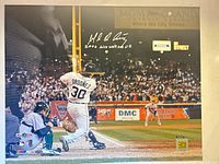 Full view of signed 16x20 photo showing player at bat and signature/numbering area