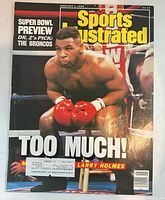 Front cover showing Mike Tyson, headline Too Much!, shipping label present