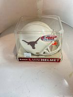 Front view of helmet in case showing longhorn logo