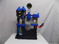 Front view of Batcave showing elevator, Batsignal and launcher