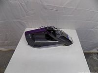 Left side view of handheld cleaner showing handle, body and branding