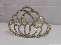 Front view of rhinestone tiara showing scalloped design and rhinestone details