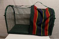 Side view of green wire mesh KittyWalk cage with striped front flap and handle