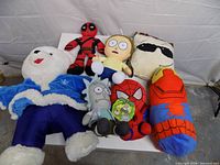 All seven plush toys arranged on table for overview