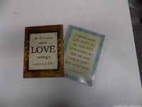 Front view of both plaques showing quotes and designs